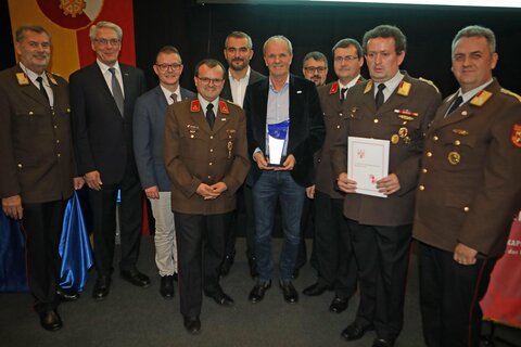 Landesfeuerwehrkommandant Alois Kögl (l.), Wirtschaftskammer-Vizepräsident Paul Kraill (2.v.l.), Landtagsabgeordneter Geza Molnar (3.v.l.) und Landesrat Heinrich Dorner (6.v.l.) mit Johann Bock (5.v.r.) und Mitarbeitern der Firma Becom.