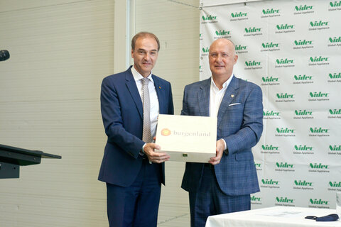 LR Schneemann (l) bedankte sich bei Nidec Global Appliance-CEO und Präsident Taranzano (r) mit burgenländischem Wein für dessen großes Engagement zum Erhalt der Produktion und der Arbeitsplätze.