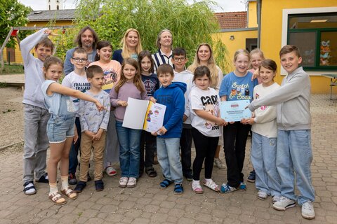 Bildungslandesrätin Daniela Winkler mit den Schülerinnen, Schülern, Lehrerinnen und Lehrern bei der Übergabe des Lesegütesiegels.