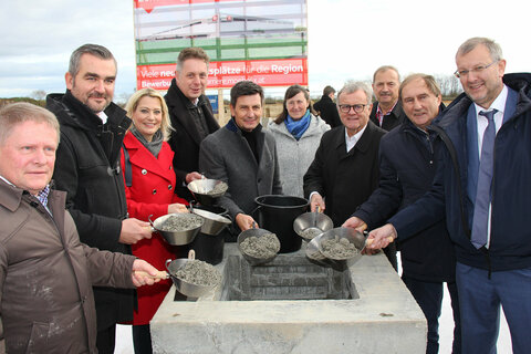 Bei der Grundsteinlegung für das Zentrallagerprojekt des Möbelhauses XXXLutz in Zurndorf wurde eine von Landesrat Christian Illedits in Vertretung von Landeshauptmann Hans Peter Doskozil, Landeshauptmann a.D. Hans Niessl, Landesrätin Mag.a (FH) Daniela Winkler, Landesrat Heinrich Dorner, Landesrat MMag. Alexander Petschnig, Bgm. LAbg. Werner Friedl, XXXLutz Unternehmenssprecher Mag. Thomas Saliger und Dr. Alois Knauseder, Leiter der XXXLutz Bauabteilung, unterzeichnete Urkunde in das Fundament einbetoniert