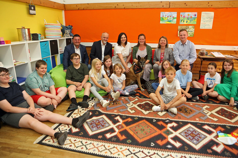 Landeshauptmann-Stellvertreterin Astrid Eisenkopf (3.v.l., hinten), Bildungsdirektor Heinz Josef Zitz (2.v.l., hinten), Rektorin Sabine Weisz (2.v.r., hinten), Bürgermeister Michael Kefeder (l., hinten) und Vizebürgermeister Christoph Frühstück (r., hinten) mit Schülerinnen und Schülern sowie einem auszubildendem Hund in der Mittelschule Lockenhaus.