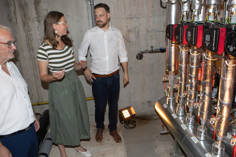 Landeshauptmann-Stellvertreterin Anja Haider-Wallner (Mitte) ließ sich von Geschäftsführer Ing. Dominik Kainz, MBA (r., im Bild mit Obmann Thomas Monetti, l.) auch das Herzstück der Anlage im Keller des OHO erklären.
